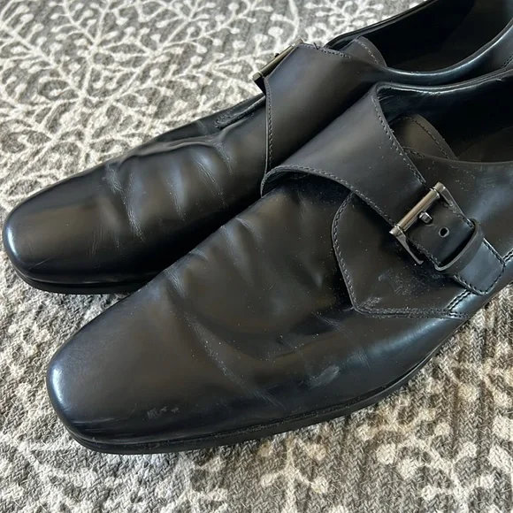 Tod’s black buckle loafers